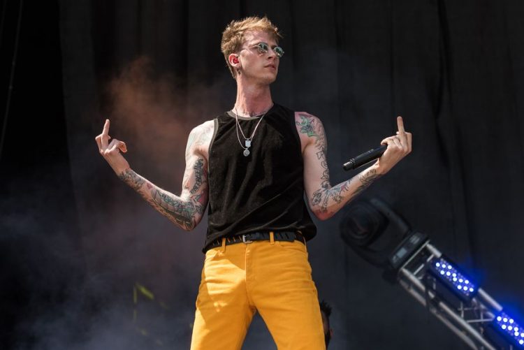 Machine Gun Kelly confronts stage crasher at Forbes event